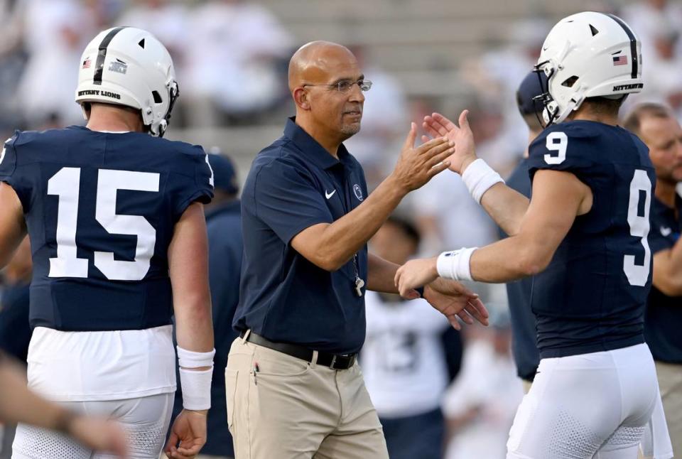 Penn State football coach James Franklin high-fives quarterback Beau Pribula during warmups for the game against West Virginia on Saturday, Sept. 2, 2023.