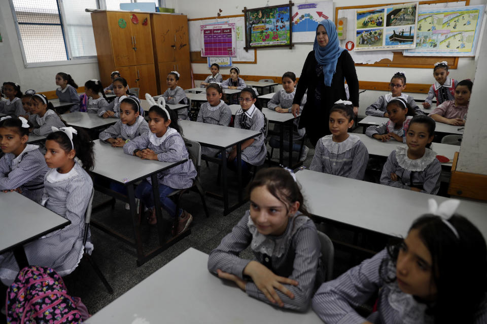 Students sit at their class on the first day of the new school year at the United-Nation run Elementary School at the Shati refugee camp in Gaza City, Saturday, Aug. 8, 2020. Schools run by both Palestinian government and the U.N. Refugee and Works Agency (UNRWA) have opened almost normally in the Gaza Strip after five months in which no cases of community transmission of the coronavirus had been recorded. (AP Photo/Adel Hana)