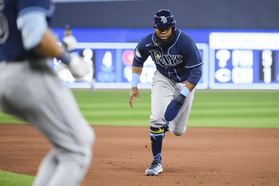 Tampa Bay Rays' Manuel Margot (13) returns to first base after Josh Lowe popped out during the fifth inning of the team's baseball game against the Toronto Blue Jays on Friday, April 14, 2023, in Toronto. (Christopher Katsarov/The Canadian Press via AP)