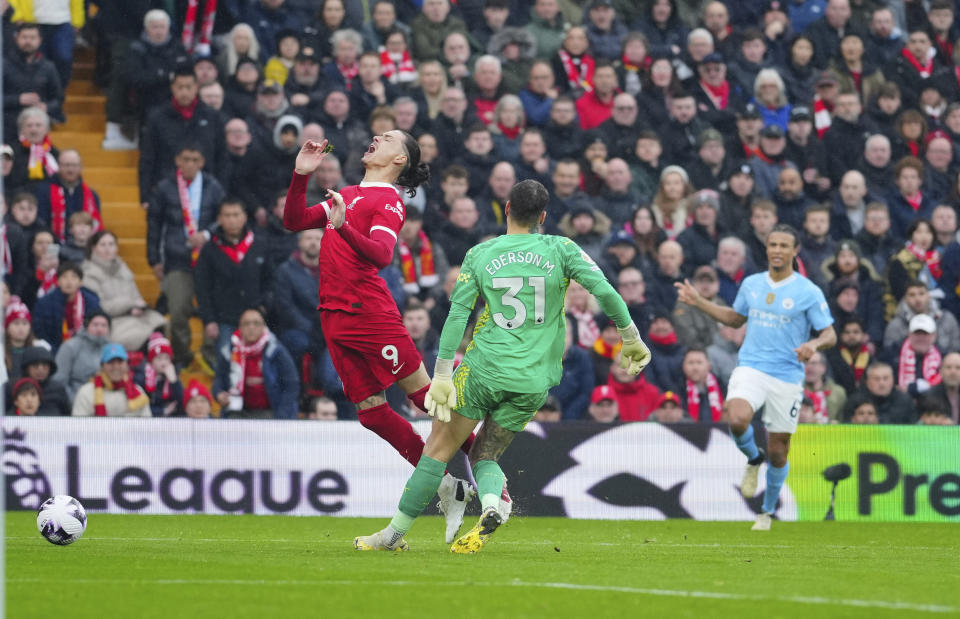 Manchester City's goalkeeper Ederson, right, stops Liverpool's Darwin Nunez during the English Premier League soccer match between Liverpool and Manchester City, at Anfield stadium in Liverpool, England, Sunday, March 10, 2024. (AP Photo/Jon Super)