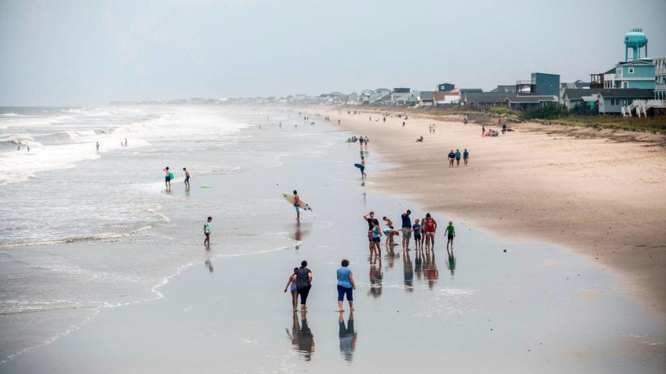 Beachgoers dot Oak Island’s beach Monday, Aug. 3, 2020.