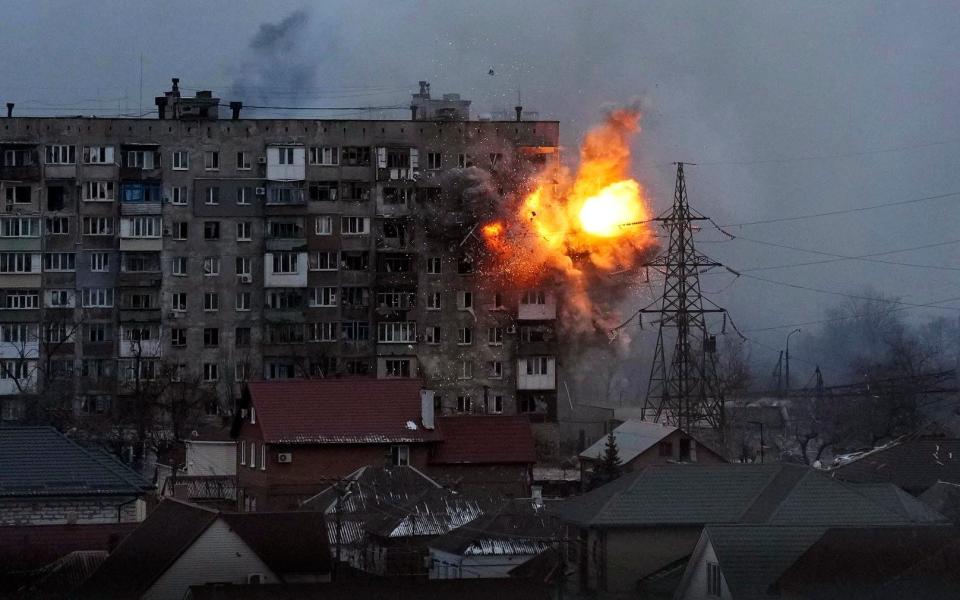 An explosion is seen in an apartment building after Russian's army tank fires in Mariupol, Ukraine, Friday, March 11, 2022. (AP Photo/Evgeniy Maloletka)  - AP