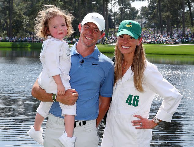 <p>Andrew Redington/Getty</p> Rory McIlroy and Erica Stoll with their daughter, Poppy, at the Par 3 contest prior to the 2023 Masters Tournament