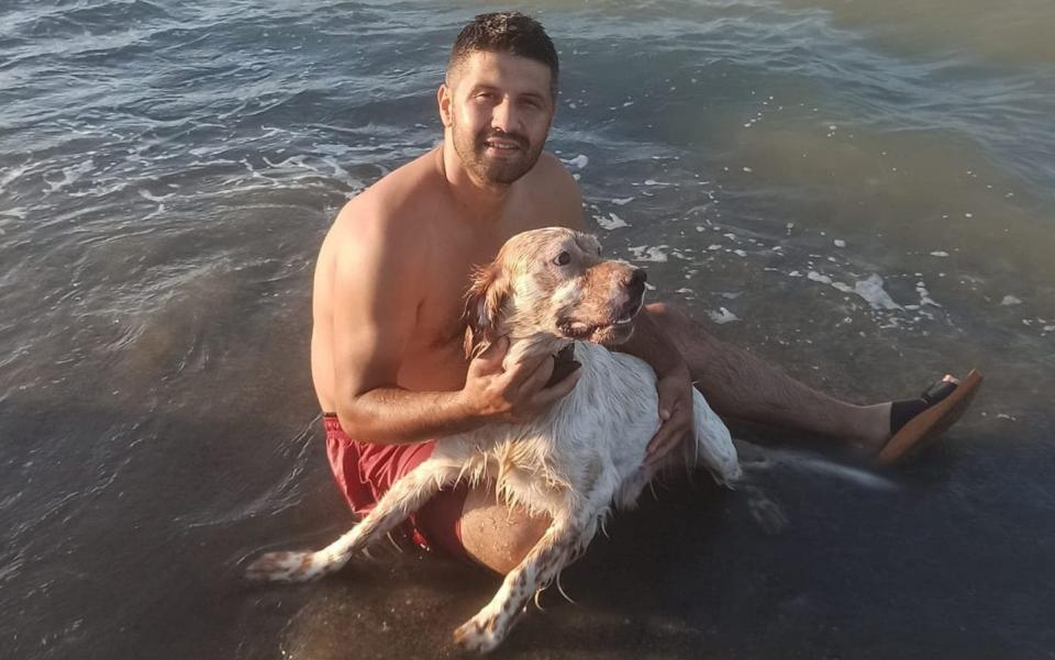 Ozgur Gevrekoglu poses with a dog. He died in Alacam, Samsun, Turkey. - Newsflash