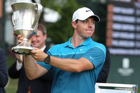 May 17, 2015; Charlotte, NC, USA; Rory McIlroy holds up the championship trophy during the final round at Quail Hollow Club. Mandatory Credit: Jim Dedmon-USA TODAY Sports