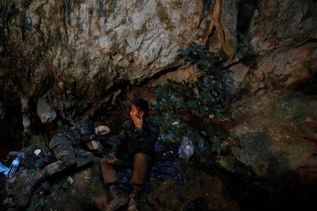 Soldiers take a rest in Tham Luang caves during a search for 12 members of an under-16 soccer team and their coach, in the northern province of Chiang Rai, Thailand, June 27, 2018. REUTERS/Soe Zeya Tun