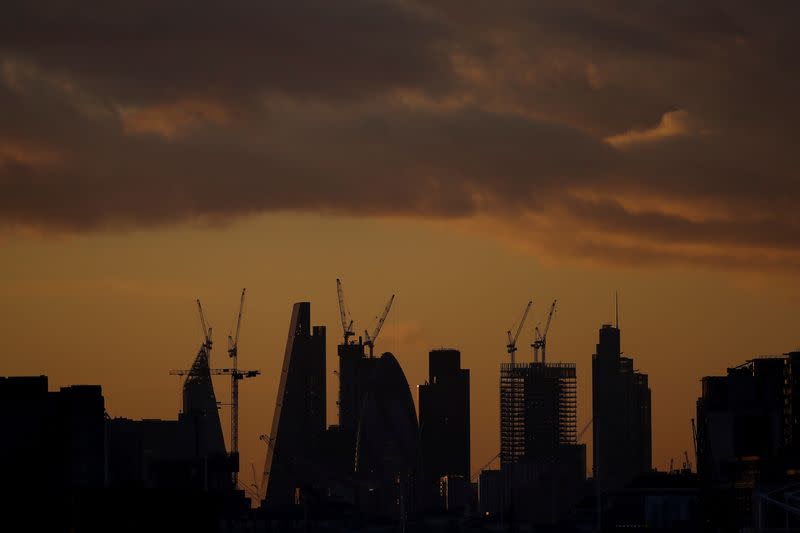 FILE PHOTO: Skyscrapers stand at sunset in the city of London's financial district in London