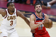 Washington Wizards' Raul Neto (19) goes up to shoot against Cleveland Cavaliers' Jeremiah Martin (3) during the second half of an NBA basketball game, Friday, April 30, 2021, in Cleveland. (AP Photo/Ron Schwane)