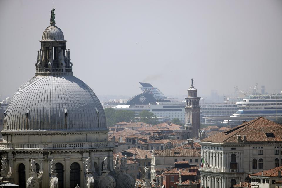 FILE-- Cruise ships are moored at Venice's harbor in Venice, Italy, Saturday, June 8, 2019. Declaring Venice's waterways a “national monument,” Italy is banning mammoth cruise liners from sailing into the lagoon city, which risked within days being declared an imperiled world heritage site by the United Nations. Culture Minister Dario Franceschini said the ban will take effect on Aug. 1 and was urgently adopted at a Cabinet meeting on Tuesday. (AP Photo/Luca Bruno)