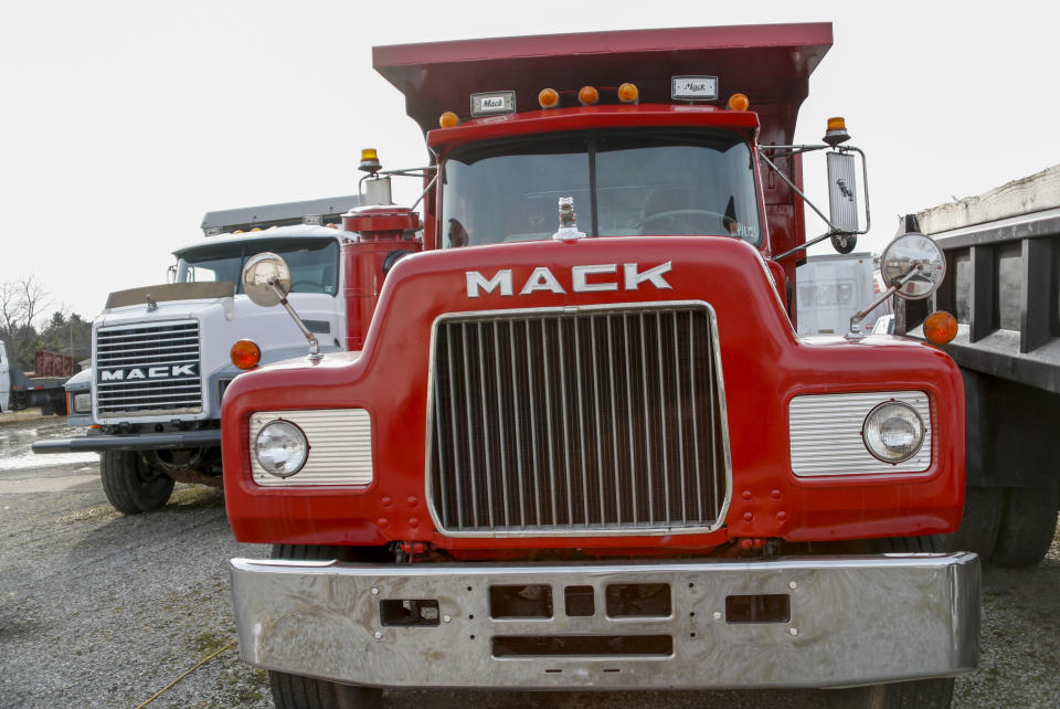 File - Used Mack trucks are parked on a lot in Evans City, Pa., on Jan. 9, 2020. Union workers at Mack Trucks have voted down a tentative five-year contract agreement reached with the company. (AP Photo/Keith Srakocic)