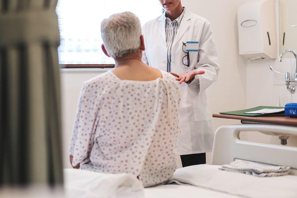 <p>Getty</p> Stock photo of healthcare worker talking to a patient.