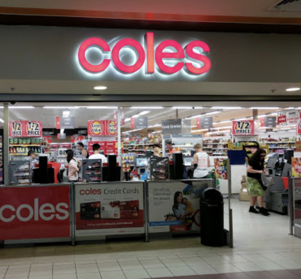Photo shows the front of a Coles store.