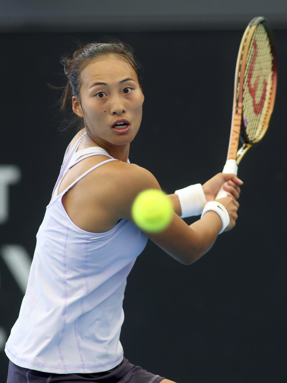 China's Qinwen Zheng makes a backhand return to Belarus' Victoria Azarenka during their Round of 16 match at the Adelaide International Tennis tournament in Adelaide, Australia, Thursday, Jan. 5, 2023. (AP Photo/Kelly Barnes)