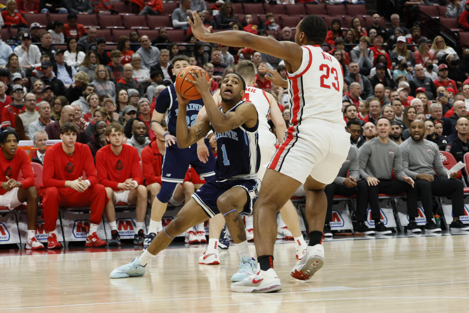 Maine's Kellen Tynes, left, looks for an open pass as Ohio State's Zed Key defends during the first half of an NCAA college basketball game on Wednesday, Dec. 21, 2022, in Columbus, Ohio. (AP Photo/Jay LaPrete)