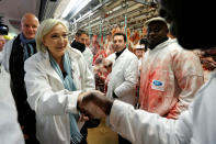 <p>Marine Le Pen (L), French National Front (FN) political party candidate for French 2017 presidential election, speaks with employees as she visits the meat pavilion at the Rungis international food market, near Paris, during her campaign, France, April 25, 2017. (Charles Platiau/Reuters) </p>