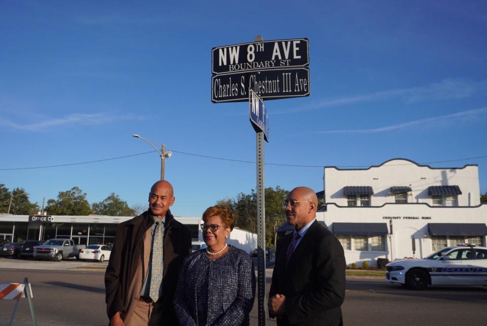 A section of Northwest Eighth Avenue between First Street and Waldo Road in Gainesville was named in honor of the late Charles S. Chestnut III on Tuesday morning. Pictured from left are Alachua County Commissioner Charles "Chuck" Chestnut IV, Gainesville City Commissioner Cynthia Chestnut and Christopher Chestnut. In the background is Chestnut Funeral Home, which has been a mainstay in the Gainesville Black community since 1914.
(Credit: Photo by Voleer Thomas, Correspondent)