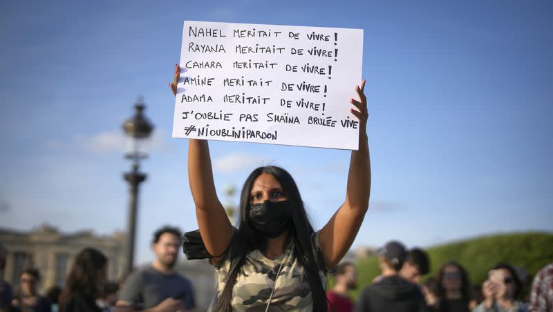 Youths gather on Concorde square during a protest in Paris, France, Friday, June 30, 2023. French President Emmanuel Macron urged parents Friday to keep teenagers at home and proposed restrictions on social media to quell rioting spreading across France over the fatal police shooting of a 17-year-old driver. Writing on poster reads in French “Nahel deserves to live, Rayana deserved to live, Camara deserved to live, Amine deserved to live, I haven’t forgotten Shaina burnt alive. Neither forgot nor forgive.”