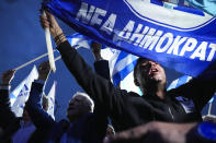 Supporters of Greece's Prime Minister and leader of New Democracy Kyriakos Mitsotakis shout slogans outside the headquarters of his party in Athens, Greece, Sunday, May 21, 2023. Prime Minister Kyriakos Mitsotakis and his conservative party are leading Greece's election by a wide margin, according to partial official results, but a new electoral law means he will be unable to form a government without seeking coalition partners, and a second election is likely. (AP Photo/Petros Giannakouris)