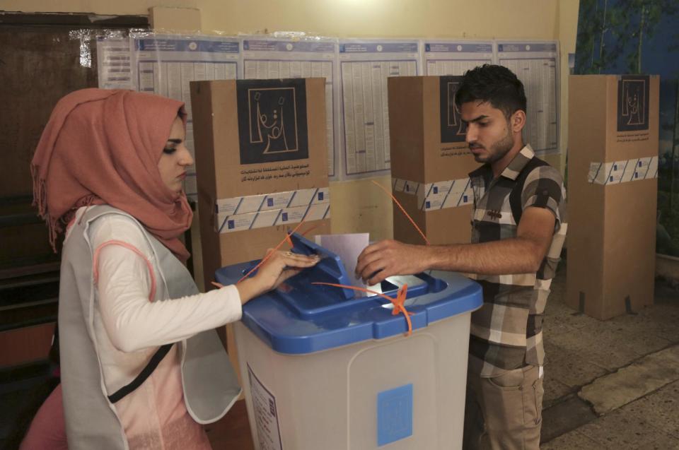 An Iraqi man casts his vote at a polling center in Baghdad, Iraq, Wednesday, April 30, 2014. A key election for a new Iraqi parliament was underway on Wednesday amid a massive security operation as the country continued to slide deeper into sectarian violence more than two years after U.S. forces left the country. (AP Photo/Khalid Mohammed)