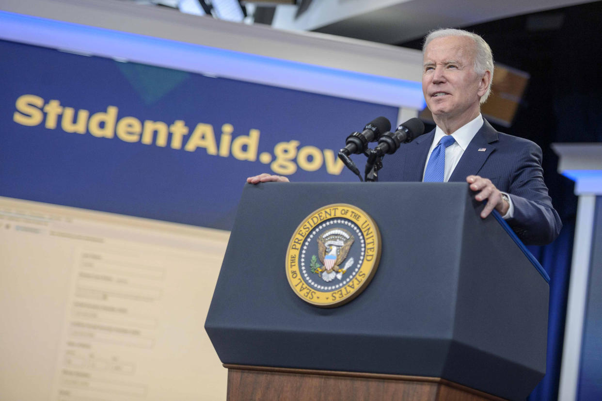 President Biden at the podium, with a banner saying StudentAid.gov behind him.