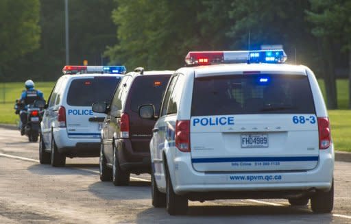 A police convoy carrying porn actor Luka Rocco Magnotta, dubbed "the Canadian Psycho", departs Mirabel Airport outside Montreal on June 18, 2012 in Mirabel, Quebec, Canada. Magnotta is accused of slaying and dismembering a Chinese student in Montreal last month, before fleeing to Europe