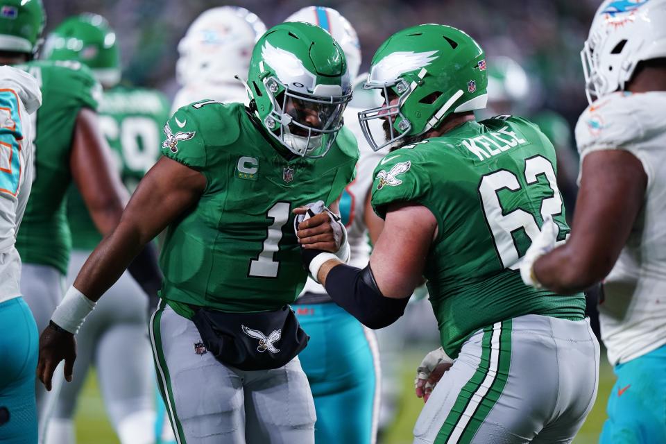 Philadelphia Eagles quarterback Jalen Hurts (1) helps up Philadelphia Eagles center Jason Kelce (62) during the first half of an NFL football game against the Miami Dolphins on Sunday, Oct. 22, 2023, in Philadelphia. (AP Photo/Chris Szagola)