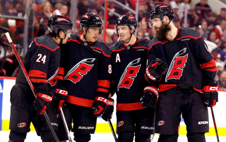 From left, Carolina’s Seth Jarvis (24), Teuvo Teravainen (86), Sebastian Aho (20) and Brent Burns (8) talk during the first period of the Hurricanes game against the Islanders in the first round of the Stanley Cup playoffs at PNC Arena in Raleigh, N.C., Monday, April 22, 2024.