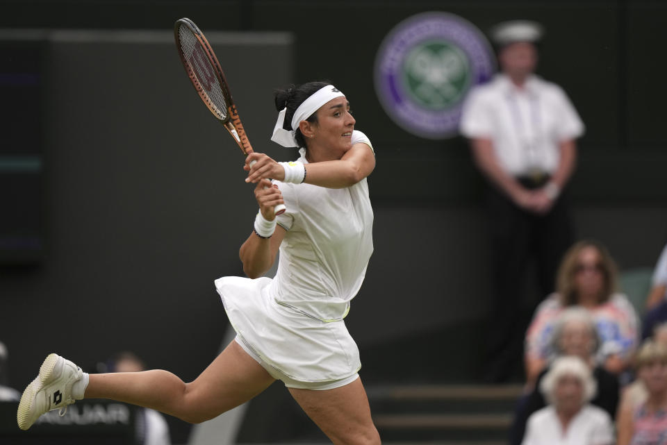 Tunisia's Ons Jabeur returns to Aryna Sabalenka of Belarus in a women's singles semifinal match on day eleven of the Wimbledon tennis championships in London, Thursday, July 13, 2023. (AP Photo/Alberto Pezzali)