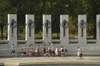 Tourists visit the World War II Memorial in Washington October 5, 2013, as the government shutdown continues into the weekend. Washington entered the fifth day of a partial government shutdown on Saturday with no end in sight even as another, more serious conflict over raising the nation's borrowing authority started heating up. (REUTERS/Mike Theiler)