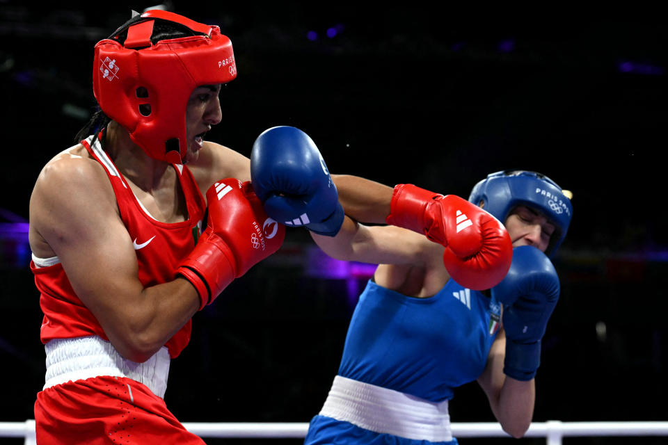 TOPSHOT - Algeria's Imane Khelif (in red) punches Italy's Angela Carini in the women's 66kg preliminaries round of 16 boxing match during the Paris 2024 Olympic Games at the North Paris Arena, in Villepinte on August 1, 2024. (Photo by MOHD RASFAN / AFP) (Photo by MOHD RASFAN/AFP via Getty Images)