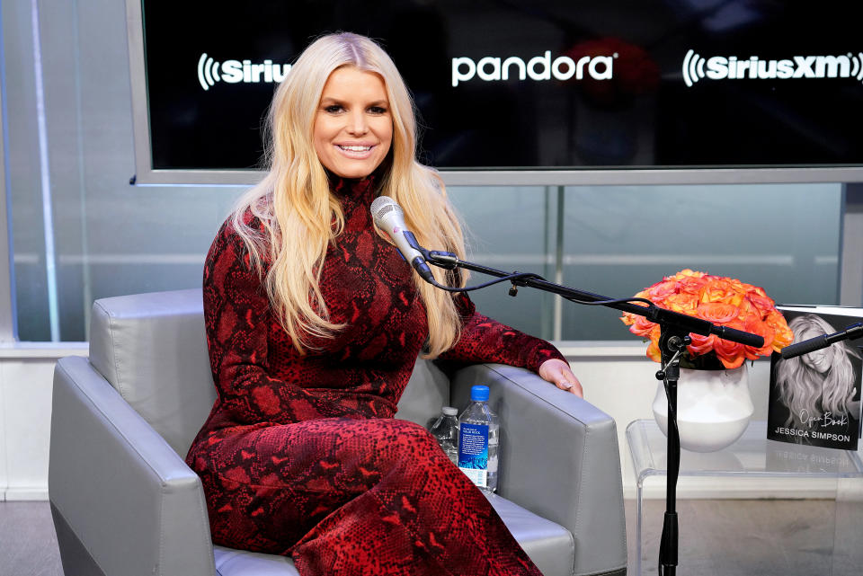 Close-up of Jessica smiling and sitting in front of a microphone