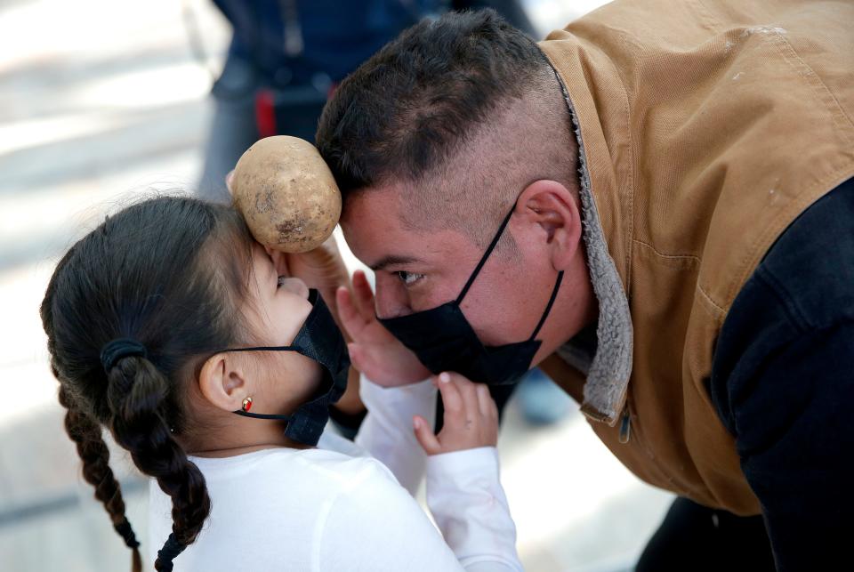 During a warm up dance session, Natalia Green, 4, dances with her father Bobby Green, who is Kickapoo, during the Potato Dance World Championships at the First Americans Museum in Oklahoma City.