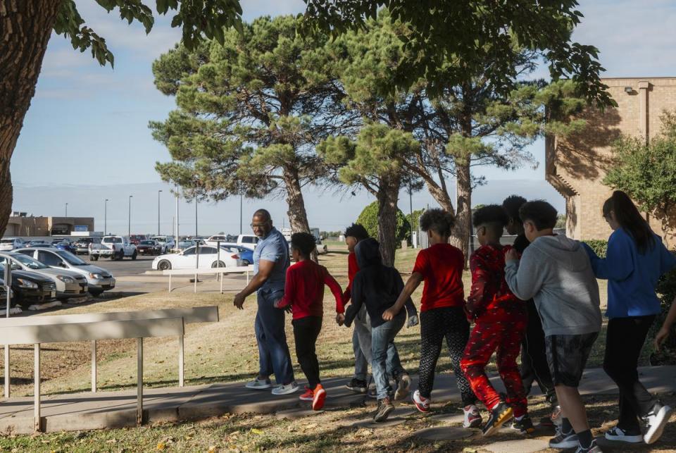 Sjohonton Fanner, 46, an assistant director of enrollment management at Vernon College, left, gives a tour of the campus to fifth grade students from Booker T. Washington elementary school on Tuesday, November 14, 2023 in Vernon. Fanner was the first in his family to graduate college and is currently deep in student debt from pursing a higher education.