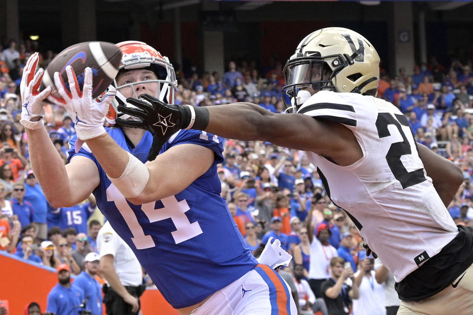 Florida wide receiver Trent Whittemore (14) catches a pass in the end zone for a 9-yard touchdown in front of Vanderbilt safety Brendon Harris (27) during the first half of an NCAA college football game, Saturday, Oct. 9, 2021, in Gainesville, Fla. (AP Photo/Phelan M. Ebenhack)