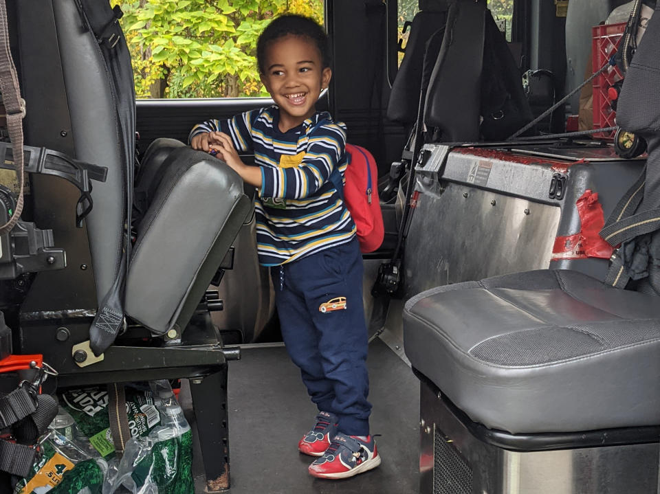 The author's son is all smiles aboard a fire truck. (Courtesy Jay Deitcher)