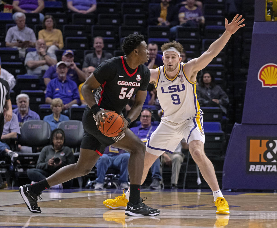 LSU forward Will Baker (9) defends against Georgia center Russel Tchewa (54) during an NCAA college basketball game Tuesday, Feb. 27, 2024, in Baton Rouge, La. (Hilary Scheinuk/The Advocate via AP)