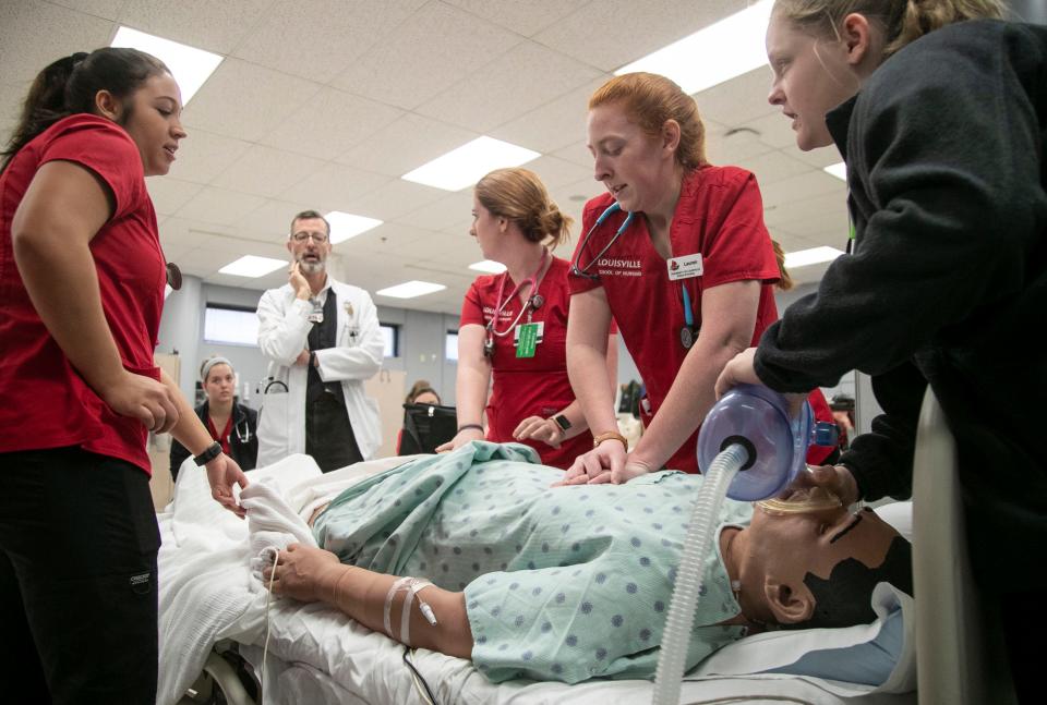 Students in UofL's School of Nursing work to resuscitate a patient during a teaching drill under assistant professor Paul Clark, RN.