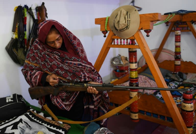 Pakistani woman Mukhtiar Naz, known as Waderi Nazo Dharejo, checks a gun at her ancestral home in Qazi Ahmed in Sindh province. Known as "Pakistan's toughest woman", she is the subject of a film which has been entered in next year's Academy Awards