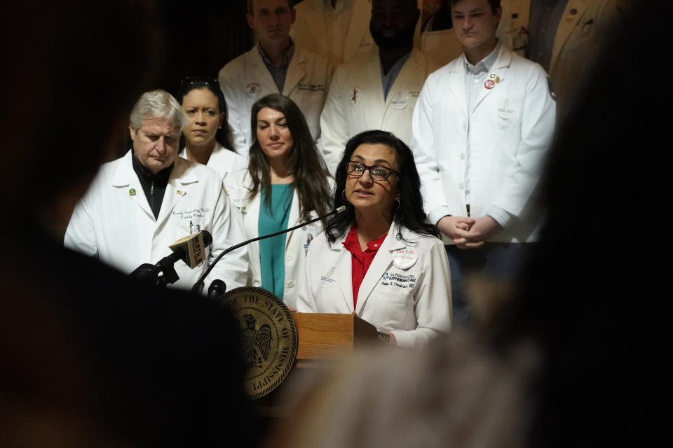 Dr. Anita Henderson, past president of the Mississippi Chapter of the American Academy of Pediatrics, is flanked by physicians and medical schools students, as she calls for the legislature's support of extending postpartum Medicaid coverage to 12 months, during a news conference at the Capitol in Jackson, Miss., Wednesday, Feb. 22, 2023. (AP Photo/Rogelio V. Solis)