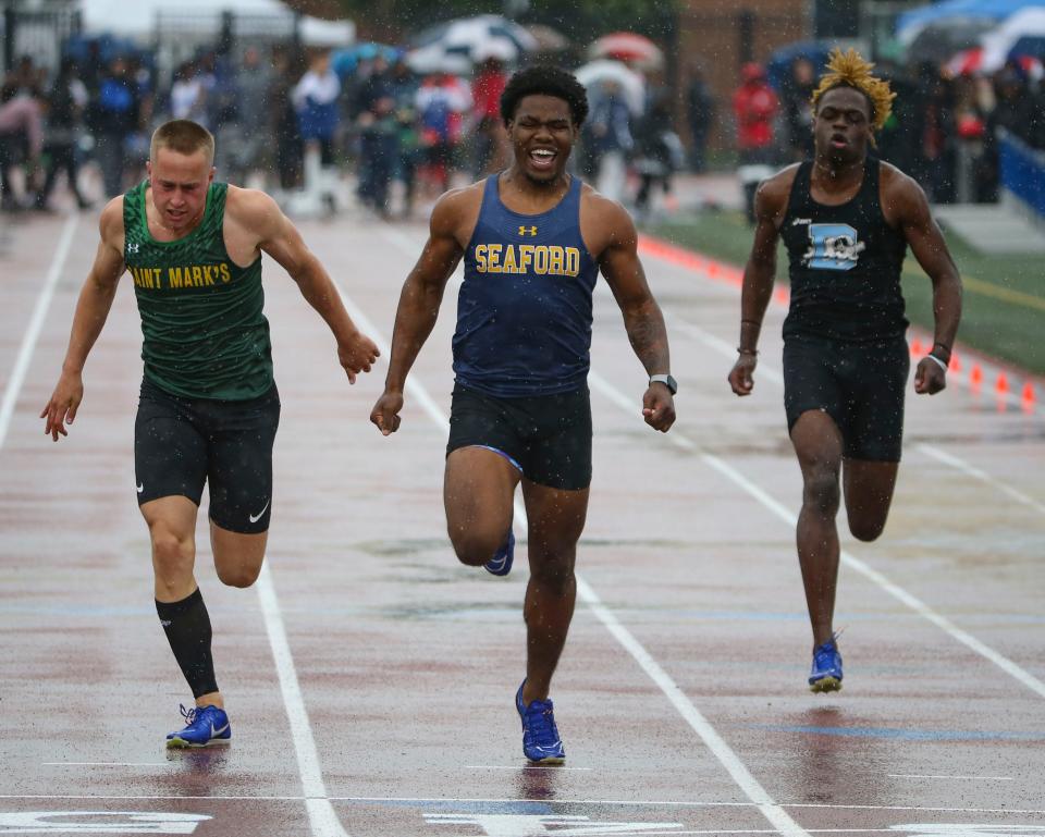 Seaford's Jazonte Levan (center) crosses the finish line first to win the state title in the Division II 100 meter dash ahead of Saint Mark's Chad Dohl in second place (left) and third place-finisher Jakai Robinson of Dickinson during the second day of the DIAA state high school track and field championships at Dover High School, Saturday, May 18, 2024.