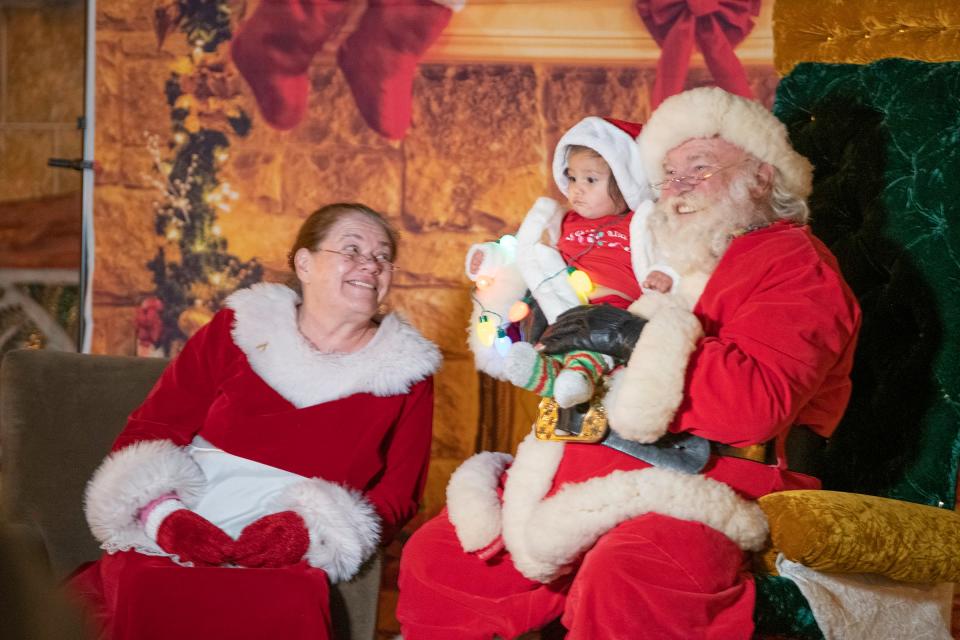 Nova Fresquez meets Santa and Mrs. Claus for the first time during the Holiday Lighting Extravaganza at the Pueblo Riverwalk on Friday, Nov. 25, 2022.