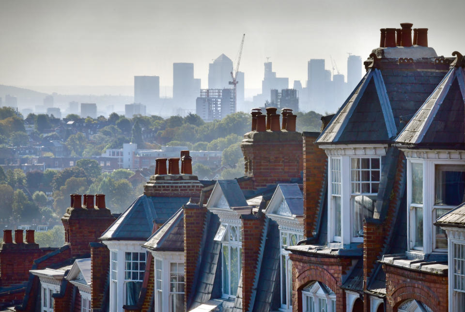 The London suburb of Muswell Hill. Rooftops of Victorian homes and street with view across London to the offices and workplaces of Canary Wharf