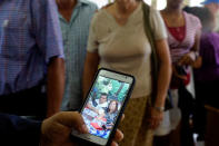 An evangelical pastor shows a picture of Ronni Pupo and Yurisel Miranda, victims of the Boeing 737 plane crash, during a religious ceremony in a church in Havana, Cuba, May 20, 2018. REUTERS/Alexandre Meneghini