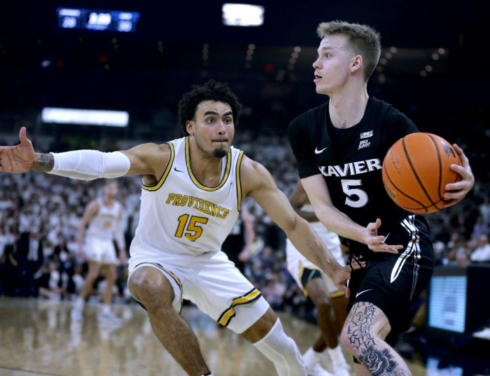 Providence's Justin Minaya defends Xavier Musketeer Adam Kunkel during a game last season, Minaya accepted a Summer League invitation from the Charlotte Hornets.