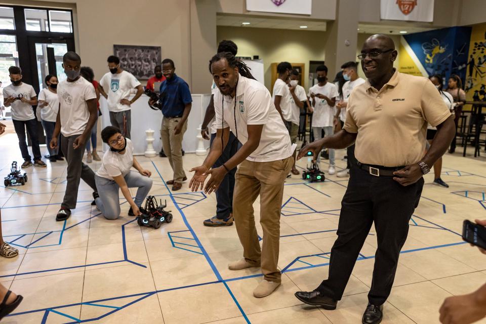 Lemuel "Life" LaRoche, executive director of Chess & Community, encourages the teams during the second challenge of the Pawn Accelerator Robotics Competition on Tuesday, June 29, 2021. Seven teams of middle or high schoolers, with assistance from college student coaches, participated in Chess & Community's second robotics competition.