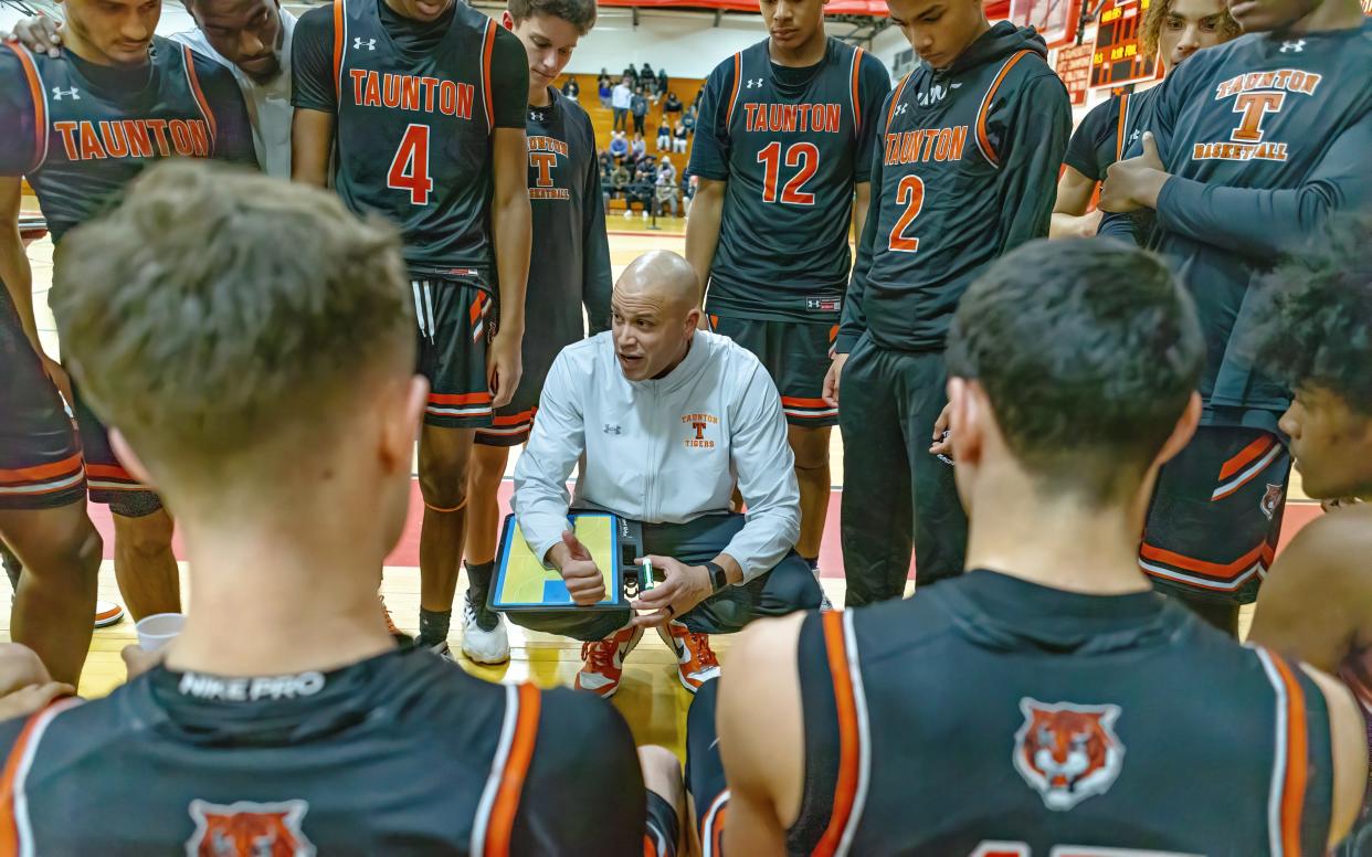 Taunton coach Colbey Santos talks with his team during a timeout of a non-league game against New Bedford.