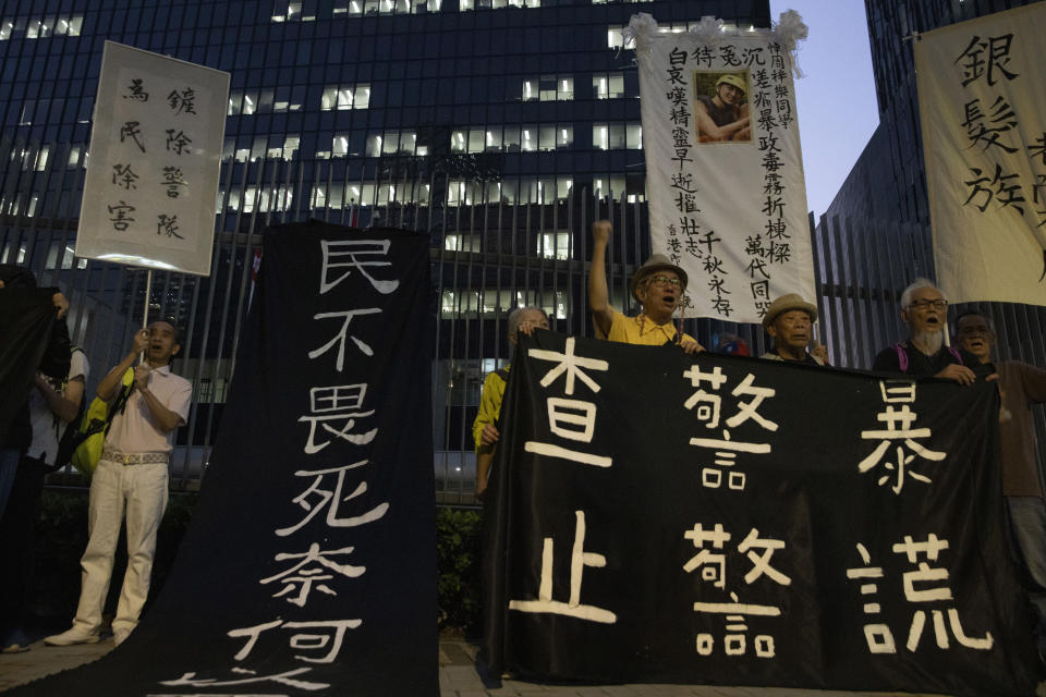 Elderly protesters lead a protest outside the Central Government Office building with banners some of which reads "Investigate police brutality, Stop police lies" and "When the people are not afraid to die, what is there to fear of death" in Hong Kong Friday, Nov. 15, 2019. Protesters who had barricaded themselves in a Hong Kong university this week began to leave Friday, after partially clearing a road they had blocked and demanding that the government commit to going forward with local elections on Nov. 24. (AP Photo/Ng Han Guan)