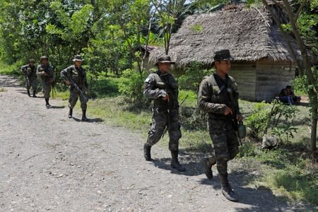 Soldiers patrol during a temporary state of siege, approved by the Guatemalan Congress following the death of several soldiers last week, in the community of Semuy II, Izabal province