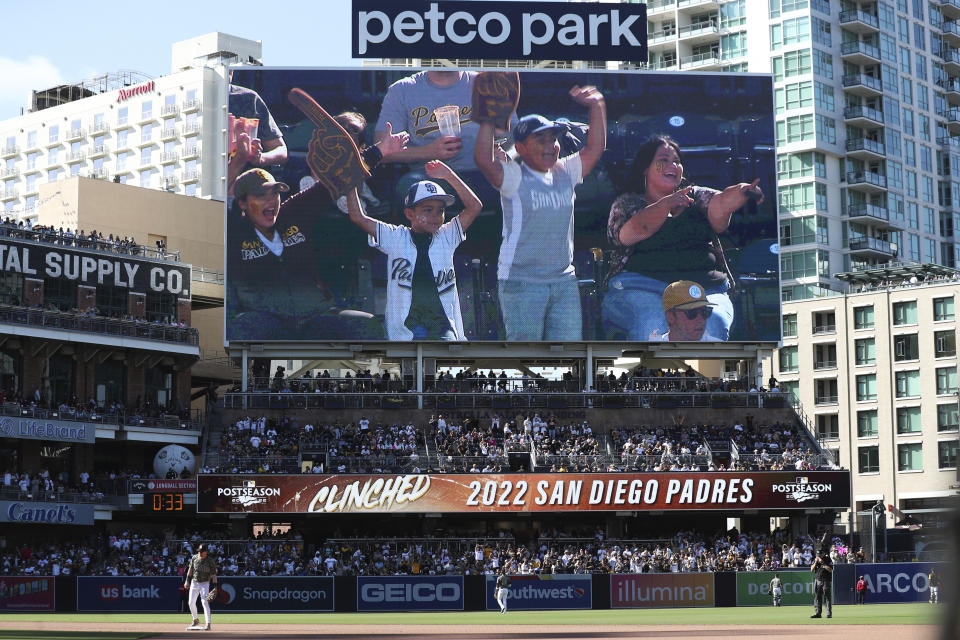 San Diego Padres' fans celebrate on the scoreboard after the team clinched a playoff berth during the eighth inning of a baseball game against the Chicago White Sox Sunday, Oct. 2, 2022, in San Diego. (AP Photo/Derrick Tuskan)