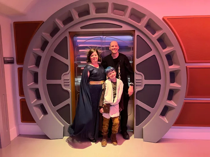 family at the entrance of the starcruiser